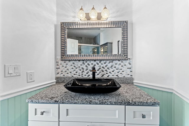 bathroom featuring tasteful backsplash and vanity