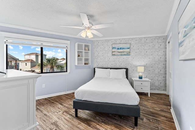 bedroom with a textured ceiling, hardwood / wood-style flooring, and ceiling fan