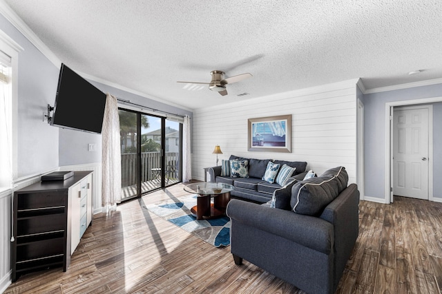 living room with a textured ceiling, hardwood / wood-style flooring, ceiling fan, and crown molding