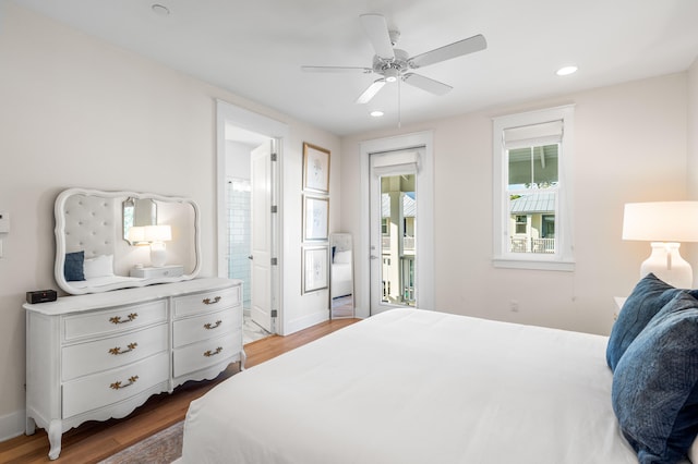 bedroom with access to outside, hardwood / wood-style floors, ceiling fan, and ensuite bathroom