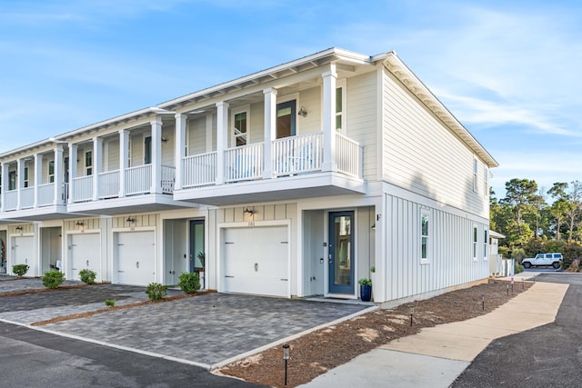 view of front facade with a garage and a balcony