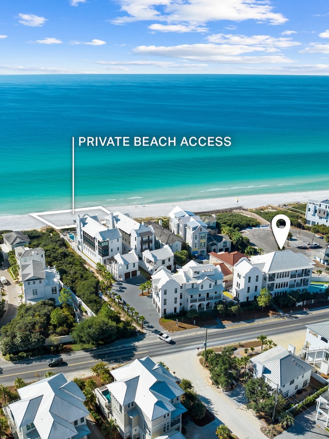 bird's eye view with a water view and a beach view