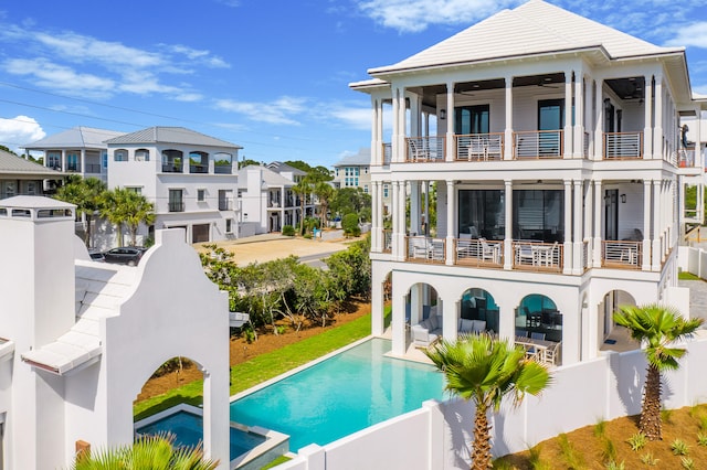 back of property with a patio area and a balcony