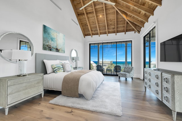 bedroom featuring access to outside, hardwood / wood-style floors, high vaulted ceiling, and wood ceiling