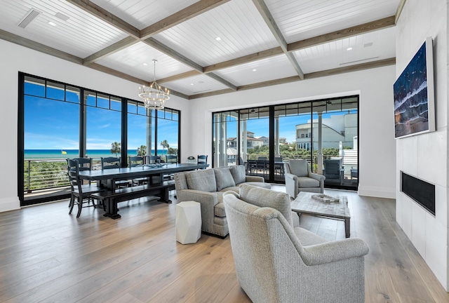 living room featuring light hardwood / wood-style floors, a notable chandelier, beamed ceiling, and wood ceiling