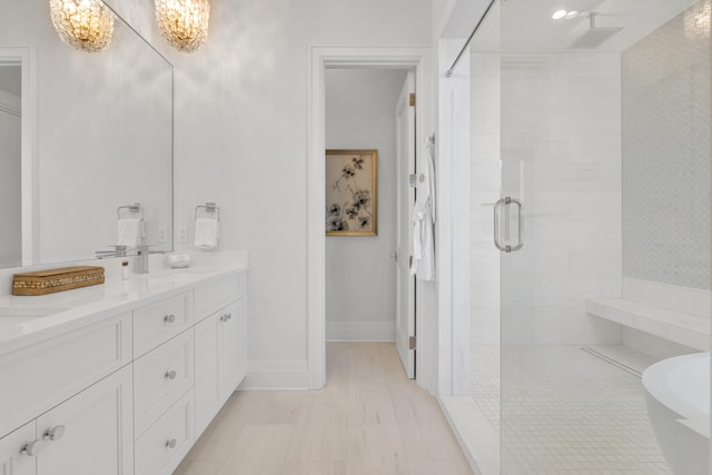 bathroom featuring vanity and shower with separate bathtub