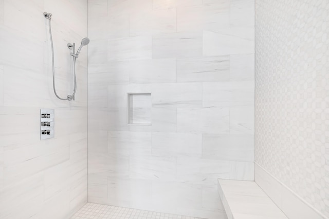 bathroom with tiled shower