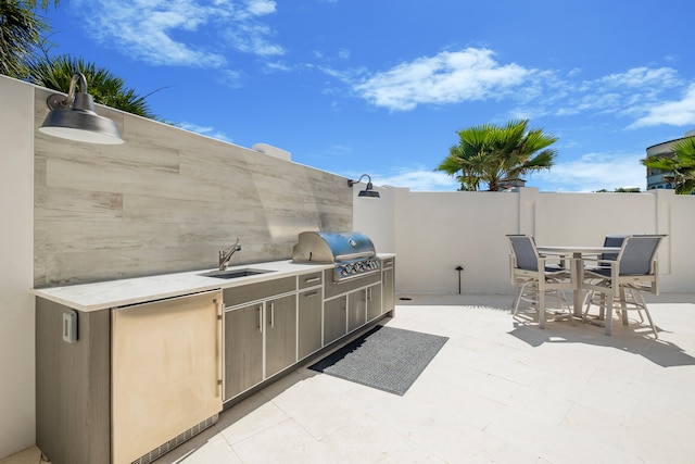 view of patio featuring grilling area, sink, and exterior kitchen