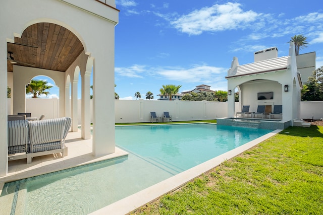 view of pool with a patio area, a lawn, and ceiling fan