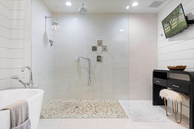 bathroom with tile patterned floors, shower with separate bathtub, and tile walls