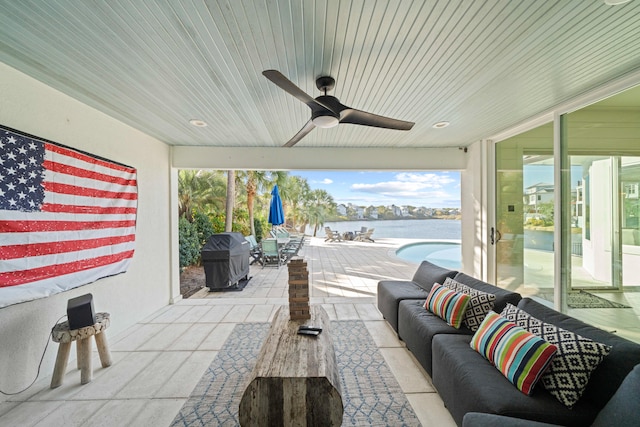 view of patio / terrace with ceiling fan, a water view, and a grill