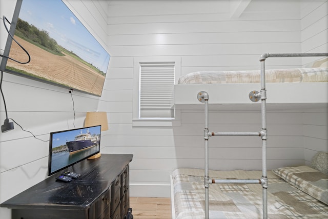 bathroom with wood walls, wood-type flooring, and beamed ceiling