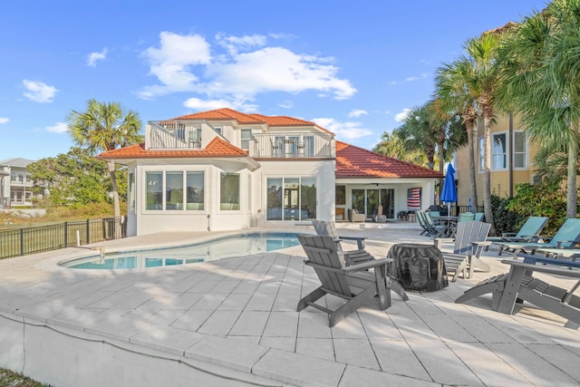 4639 Destiny Way, Destin, FL 32541 - rear view of property featuring a balcony, a tiled roof, a patio area, stucco siding, and fence