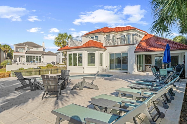 4639 Destiny Way, Destin, FL 32541 - back of house featuring a balcony, a tile roof, fence, a patio area, and stucco siding