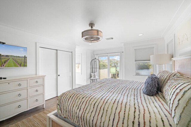 bedroom featuring a closet, access to outside, crown molding, dark hardwood / wood-style flooring, and ceiling fan