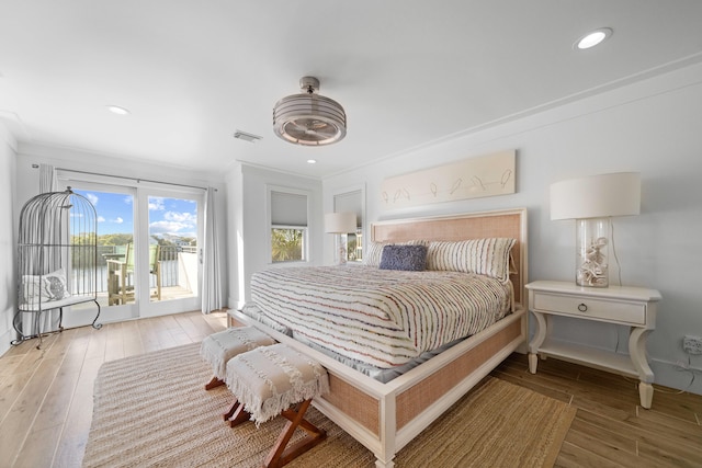 bedroom with access to exterior, ornamental molding, and hardwood / wood-style flooring