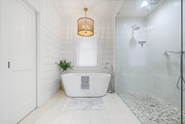 bathroom featuring tile patterned flooring and shower with separate bathtub