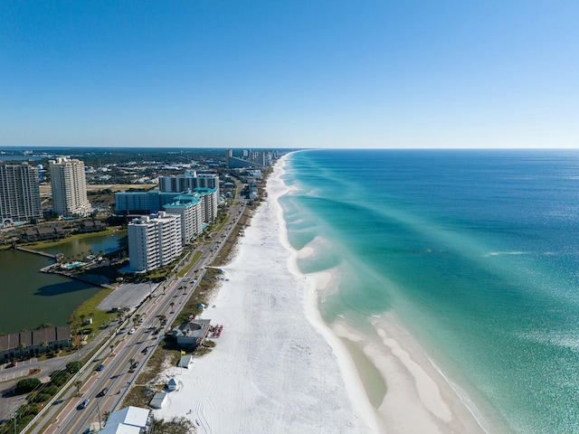 drone / aerial view with a water view and a beach view