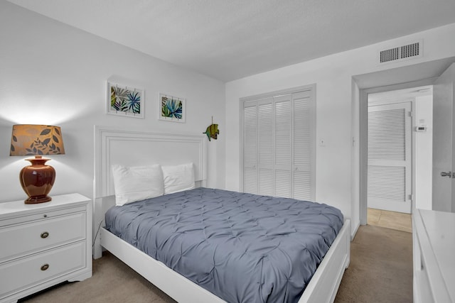 bedroom featuring light carpet and a closet