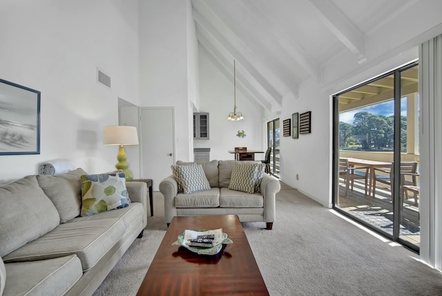 carpeted living room with beamed ceiling, a chandelier, and high vaulted ceiling