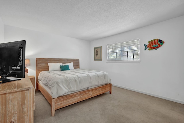 bedroom with carpet and a textured ceiling