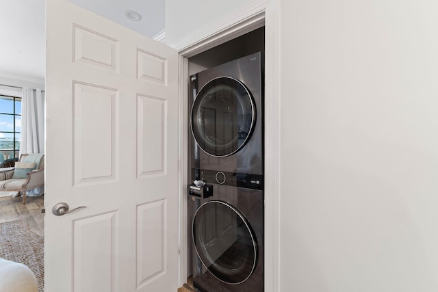 10343 E County Highway 30a Unit 316, Seacrest, FL 32461 - laundry area with stacked washer / drying machine and wood finished floors