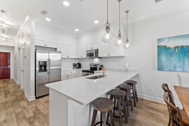 10343 E County Highway 30a Unit 316, Seacrest, FL 32461 - kitchen featuring appliances with stainless steel finishes, a peninsula, ornamental molding, a breakfast bar, and light countertops