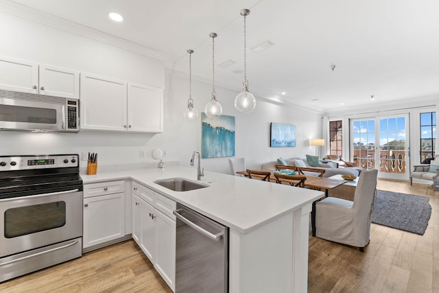 10343 E County Highway 30a Unit 316, Seacrest, FL 32461 - kitchen with stainless steel appliances, a sink, open floor plan, ornamental molding, and light countertops