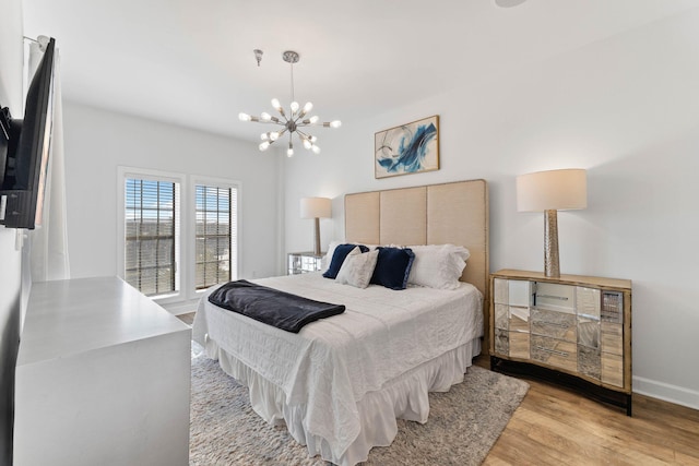 10343 E County Highway 30a Unit 316, Seacrest, FL 32461 - bedroom with light wood-type flooring, a chandelier, and baseboards