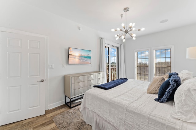 10343 E County Highway 30a Unit 316, Seacrest, FL 32461 - bedroom featuring a chandelier, wood finished floors, multiple windows, and baseboards
