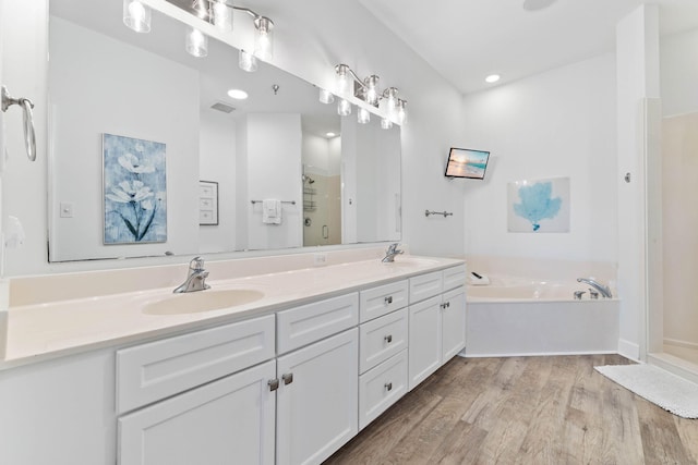 10343 E County Highway 30a Unit 316, Seacrest, FL 32461 - full bathroom featuring double vanity, wood finished floors, a stall shower, and a garden tub