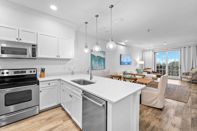 10343 E County Highway 30a Unit 316, Seacrest, FL 32461 - kitchen featuring stainless steel appliances, ornamental molding, a sink, open floor plan, and a peninsula