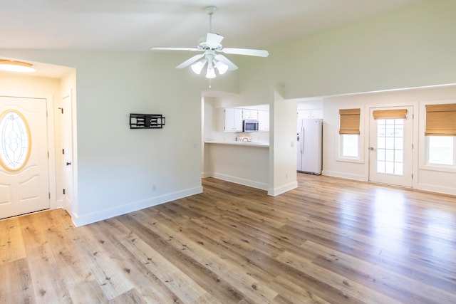 entryway featuring ceiling fan, light hardwood / wood-style flooring, and lofted ceiling