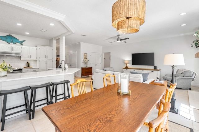 dining area with ceiling fan, light tile patterned floors, recessed lighting, ornamental molding, and ornate columns