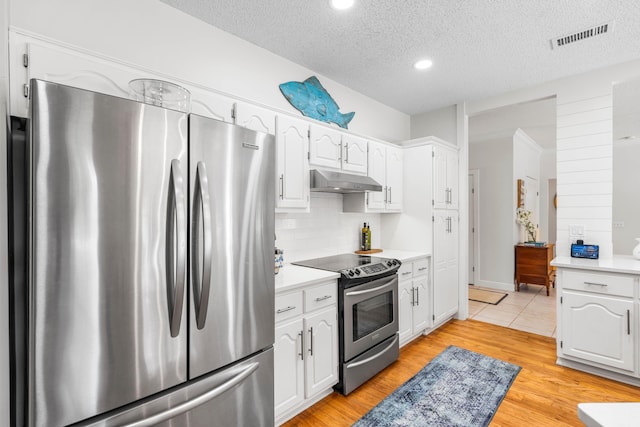 kitchen featuring appliances with stainless steel finishes, under cabinet range hood, white cabinets, light countertops, and a textured ceiling