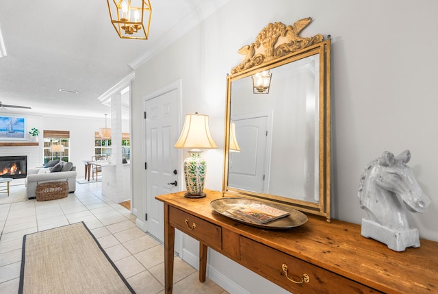 tiled entryway featuring ornamental molding and a textured ceiling