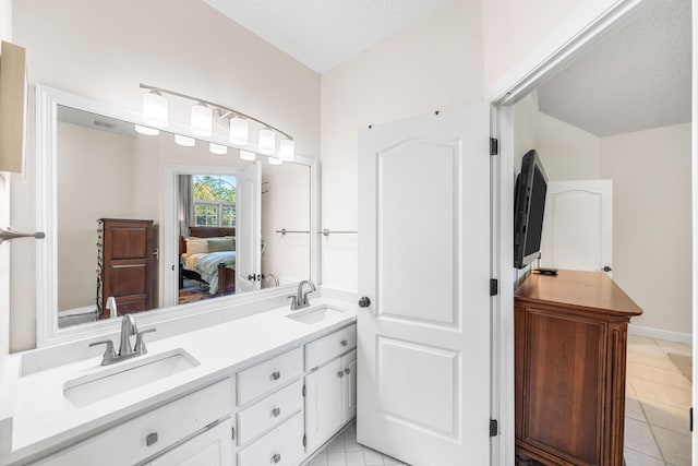 bathroom featuring vanity, a textured ceiling, and tile patterned floors