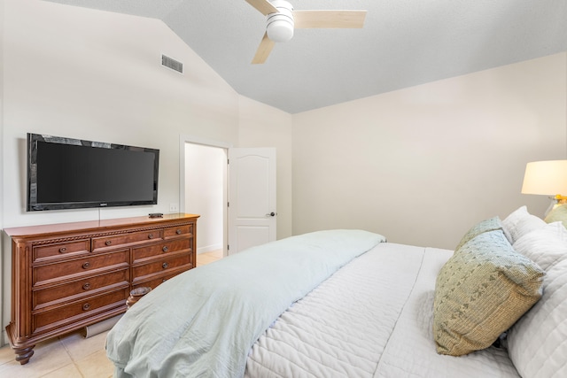 tiled bedroom with ceiling fan and vaulted ceiling