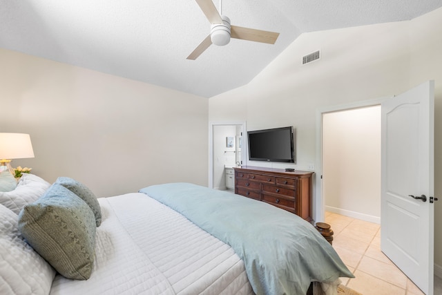 bedroom with ceiling fan, ensuite bath, light tile patterned floors, and lofted ceiling