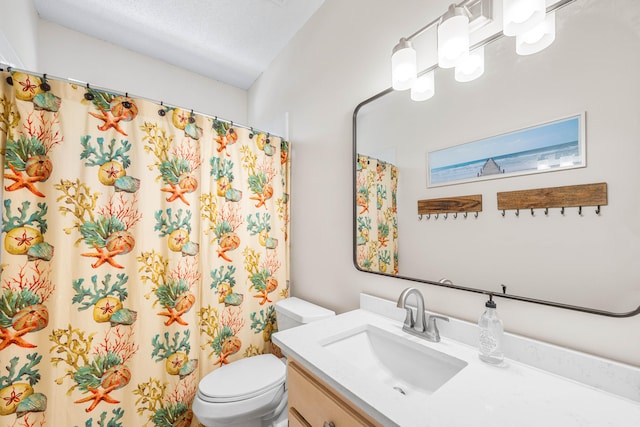 bathroom featuring toilet, vanity, a textured ceiling, and walk in shower