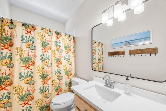 bathroom featuring toilet, vanity, and a shower with curtain