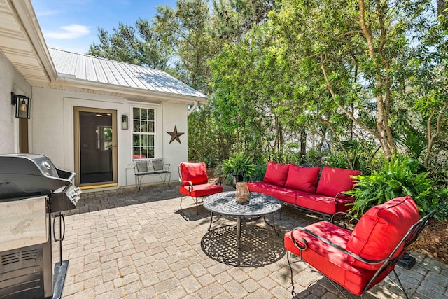 view of patio / terrace with an outdoor living space and a grill