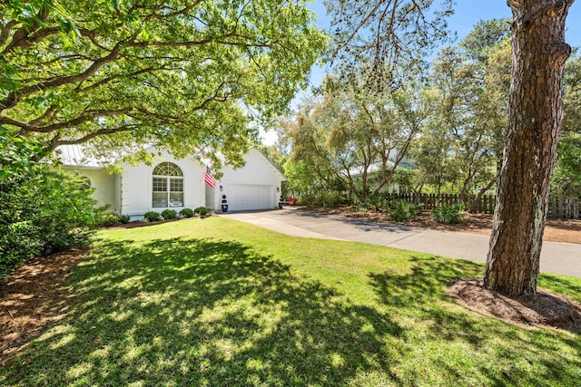view of yard featuring driveway and an attached garage