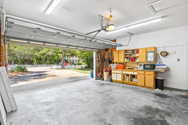 garage featuring a garage door opener and a workshop area