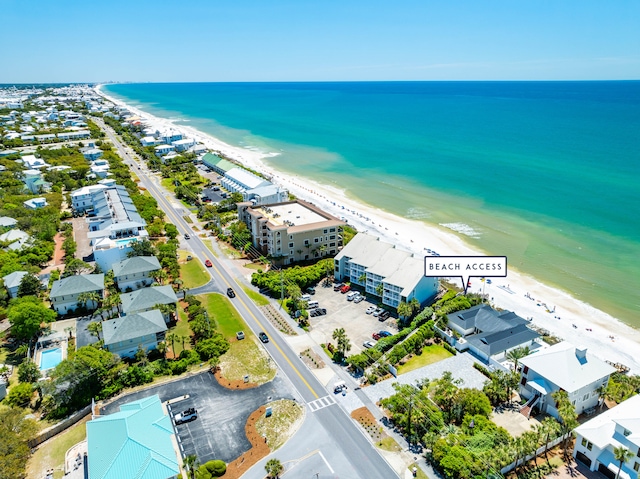 birds eye view of property featuring a water view and a beach view