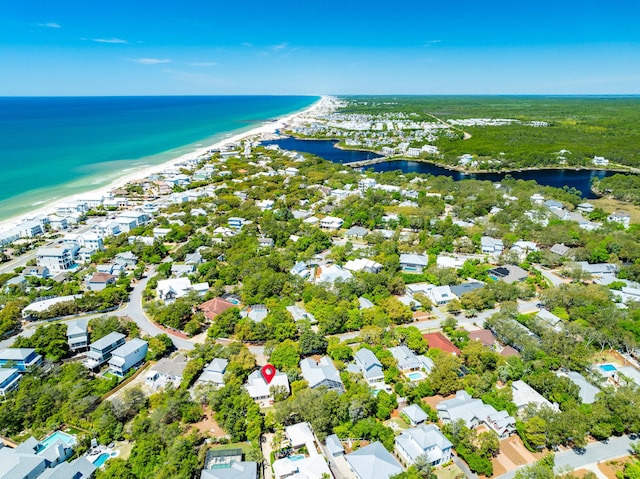 drone / aerial view with a beach view and a water view