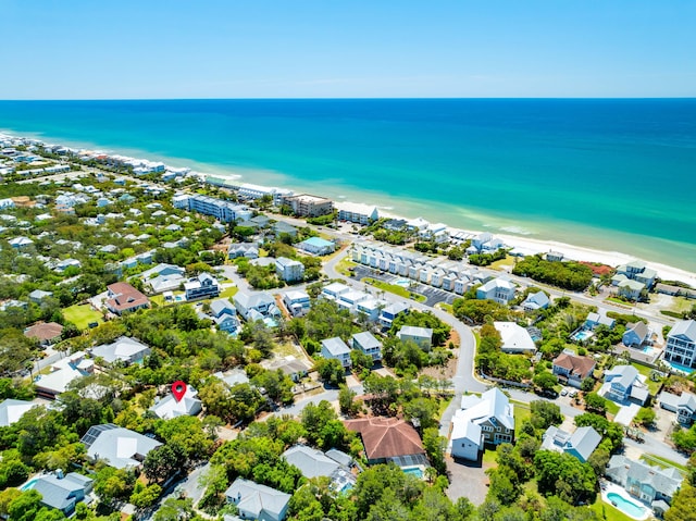 bird's eye view with a water view and a beach view