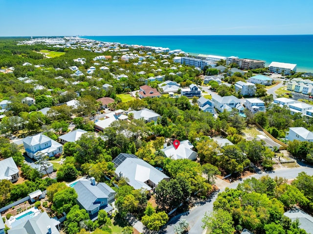 aerial view of residential area featuring a large body of water