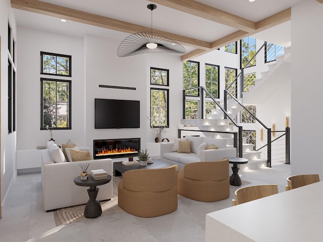 living room with beam ceiling and a high ceiling