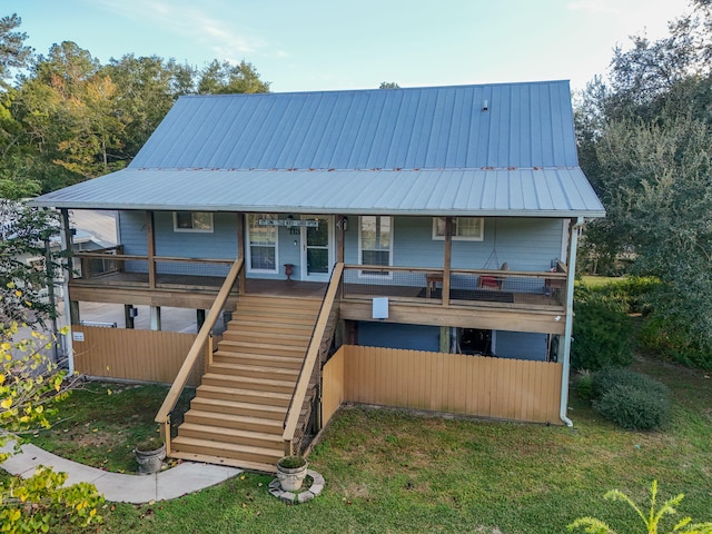 rear view of property with a yard